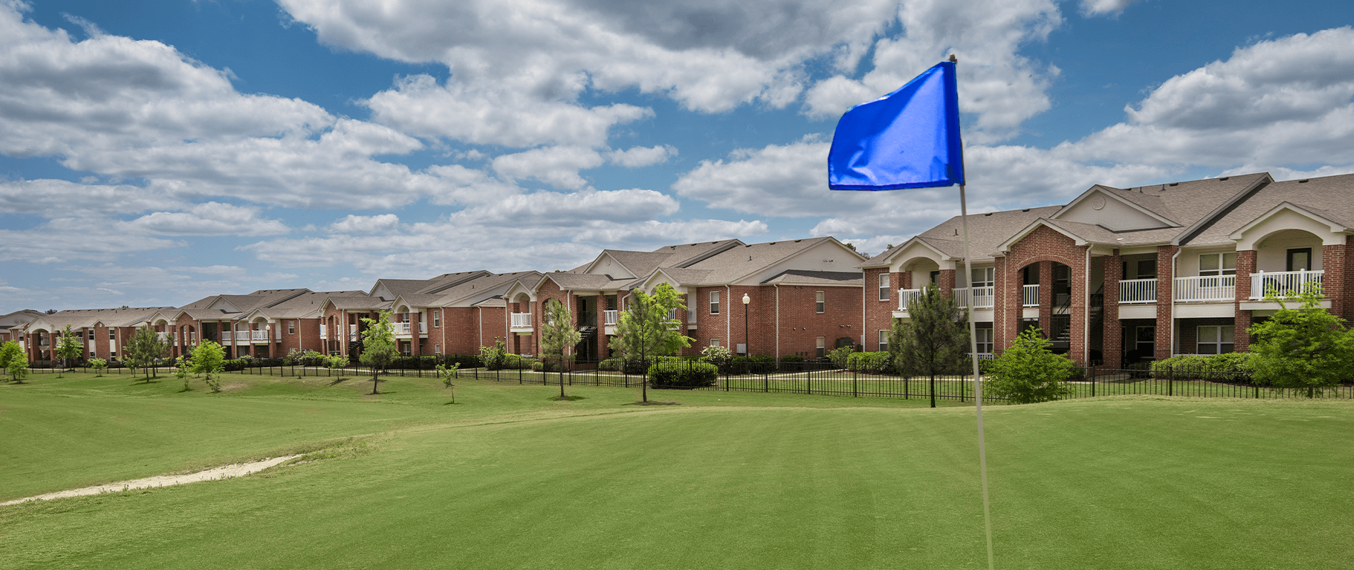 a blue flag flies in front of a row of houses